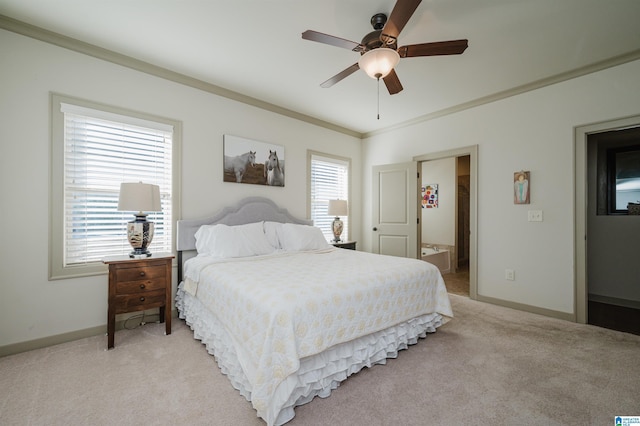 bedroom featuring crown molding, light carpet, connected bathroom, ceiling fan, and baseboards