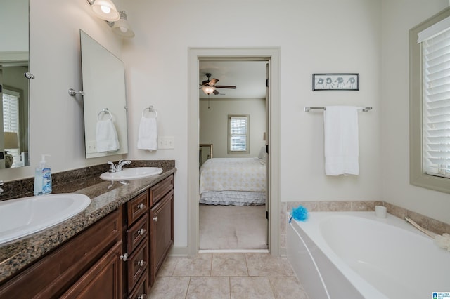 bathroom with a garden tub, connected bathroom, a sink, and tile patterned floors