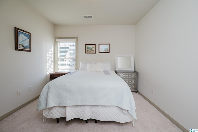 bedroom featuring light carpet, baseboards, and visible vents