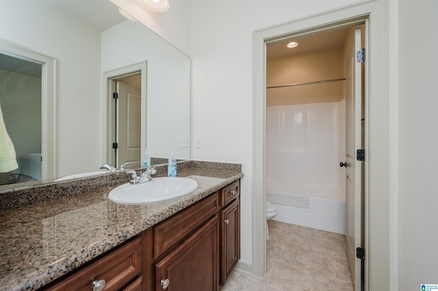 bathroom with tile patterned flooring, bathing tub / shower combination, vanity, and toilet