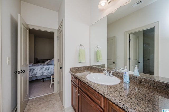 bathroom featuring vanity, tile patterned flooring, connected bathroom, and visible vents