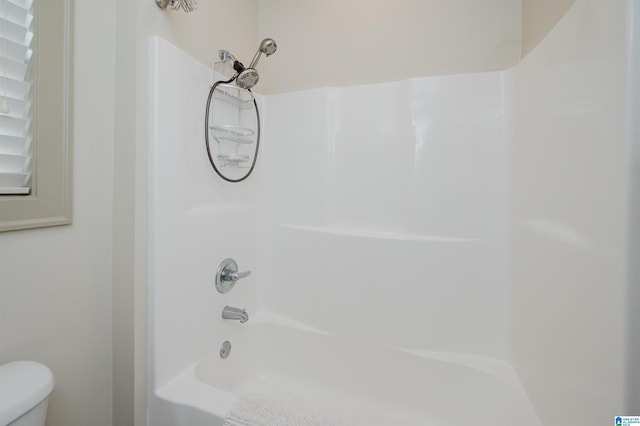 bathroom with shower / tub combination and toilet