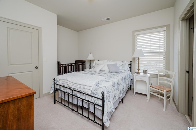 bedroom featuring light carpet and visible vents