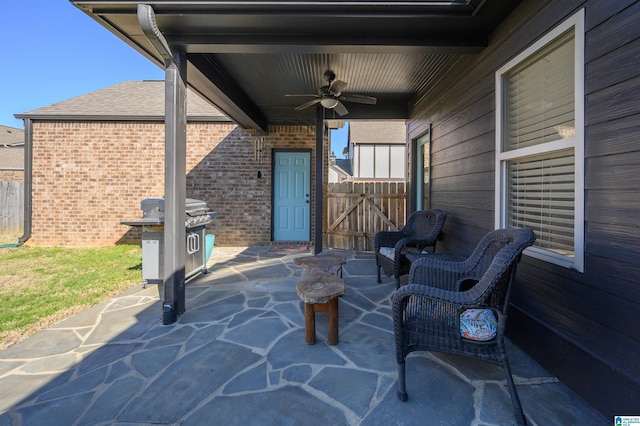 view of patio / terrace with ceiling fan, a gate, and fence