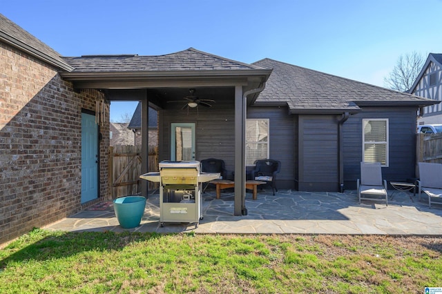 rear view of property with a patio area, fence, and brick siding