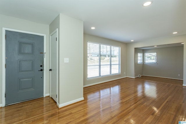 entryway with baseboards, wood finished floors, and recessed lighting