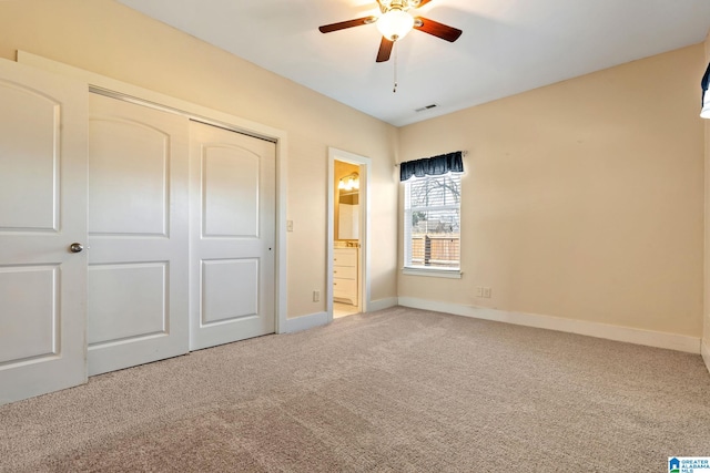 unfurnished bedroom with connected bathroom, visible vents, baseboards, a closet, and carpet