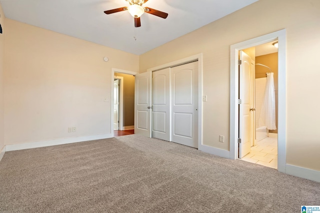 unfurnished bedroom with ceiling fan, a closet, carpet flooring, and baseboards