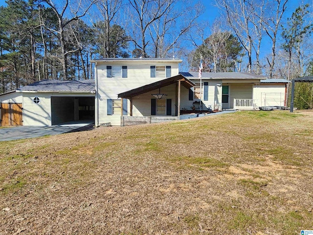 rear view of property with metal roof, a porch, a yard, driveway, and a carport