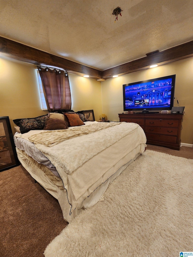 bedroom featuring carpet and a textured ceiling