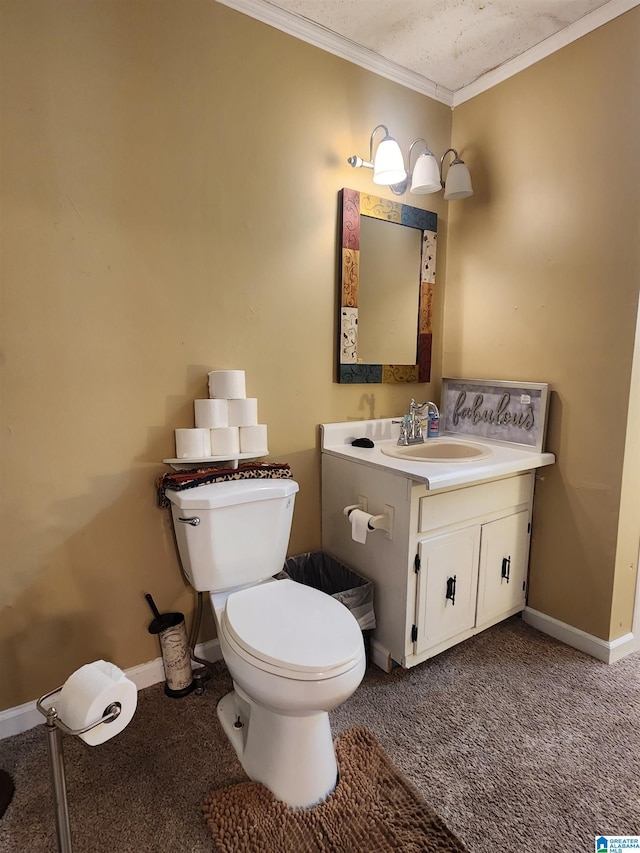 bathroom with toilet, baseboards, crown molding, and vanity