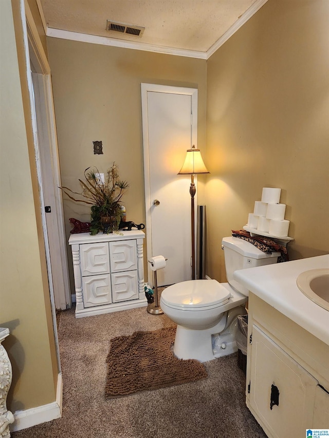 bathroom featuring toilet, vanity, visible vents, and ornamental molding