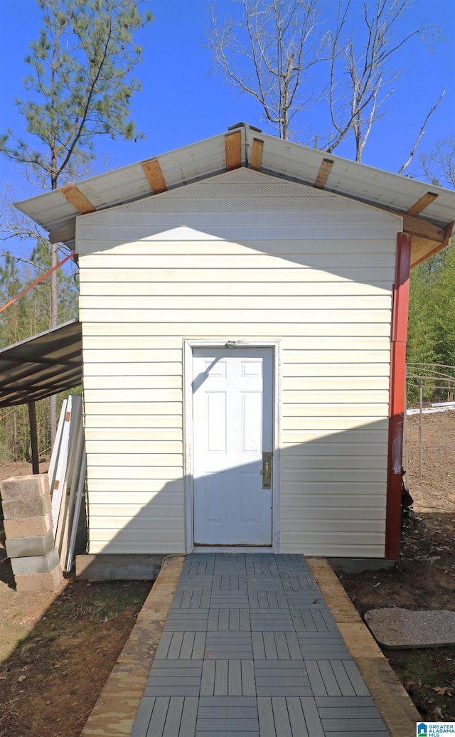 view of outbuilding featuring a carport and an outdoor structure