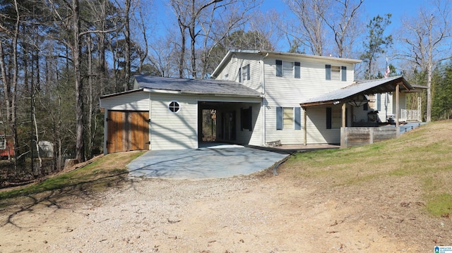 view of front of home featuring driveway and a patio