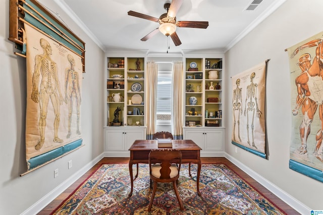 home office with baseboards, visible vents, ceiling fan, ornamental molding, and wood finished floors