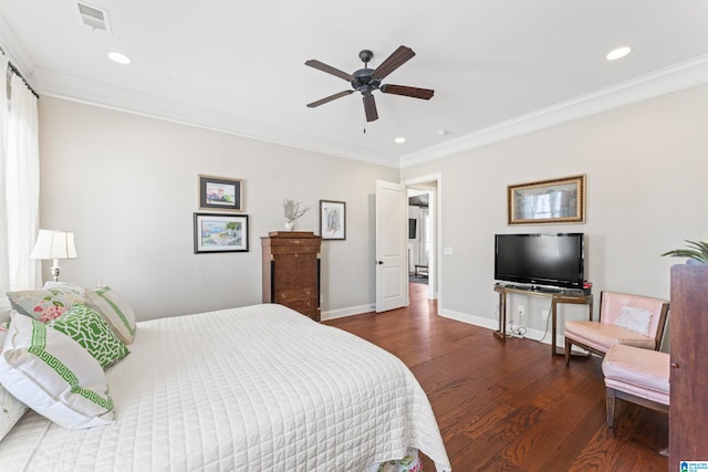 bedroom featuring baseboards, wood finished floors, and crown molding