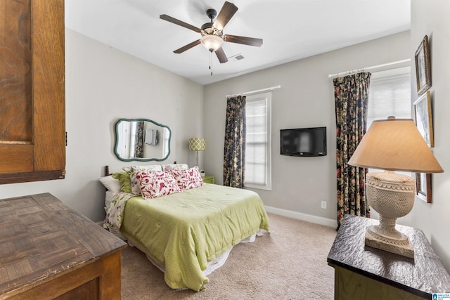 carpeted bedroom with ceiling fan, visible vents, and baseboards