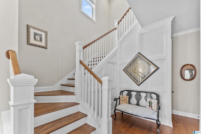 stairway with hardwood / wood-style flooring and baseboards