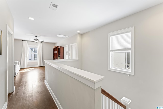 hall with recessed lighting, visible vents, an upstairs landing, baseboards, and dark wood-style floors