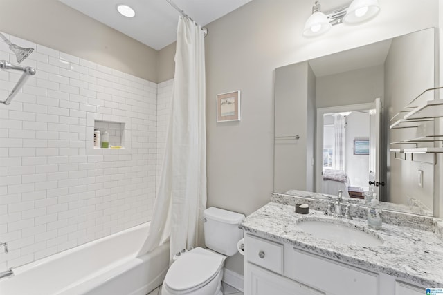 bathroom with toilet, shower / tub combo with curtain, and vanity