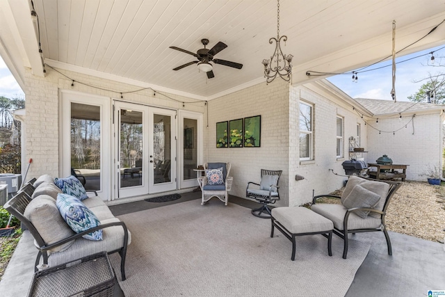 view of patio / terrace featuring ceiling fan, an outdoor living space, and french doors