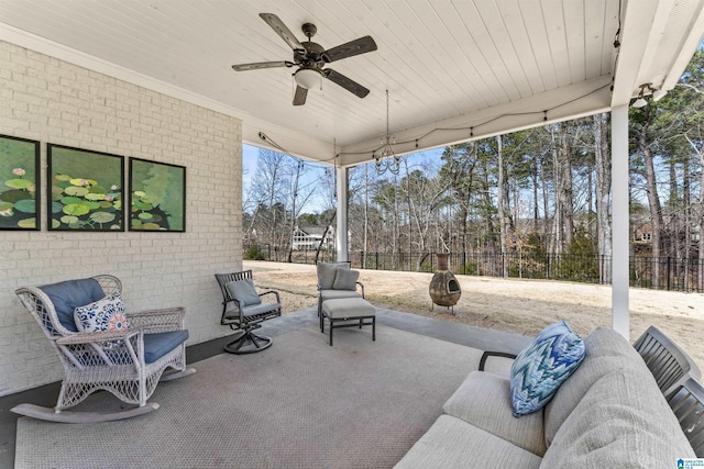 view of patio / terrace with outdoor lounge area, a fenced backyard, and a ceiling fan