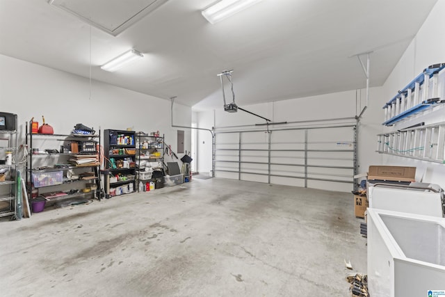 garage featuring electric panel and a garage door opener