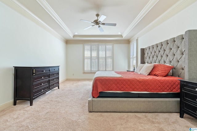 bedroom featuring ornamental molding, carpet floors, a tray ceiling, and baseboards