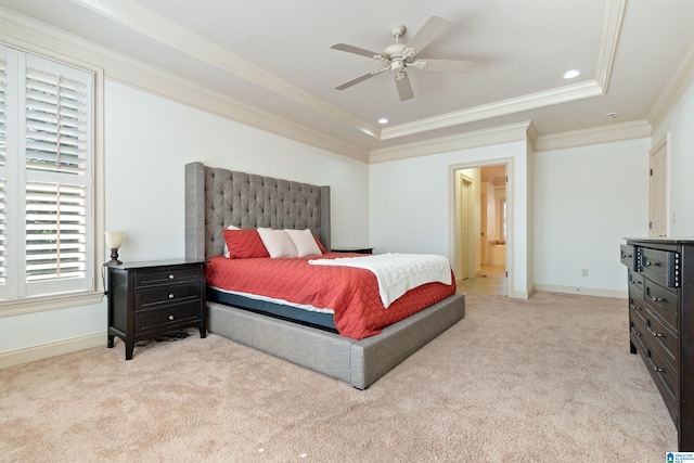 bedroom featuring light carpet, baseboards, and a raised ceiling