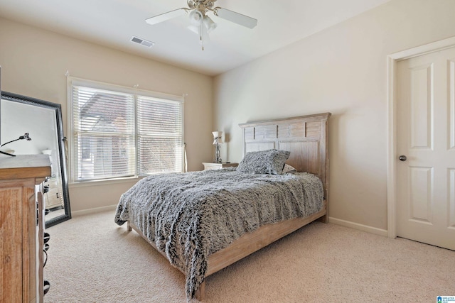 carpeted bedroom with visible vents, ceiling fan, and baseboards