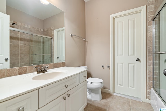 bathroom featuring vanity, tile patterned flooring, and toilet