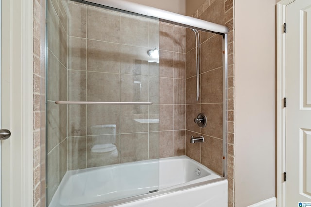 full bath featuring bath / shower combo with glass door