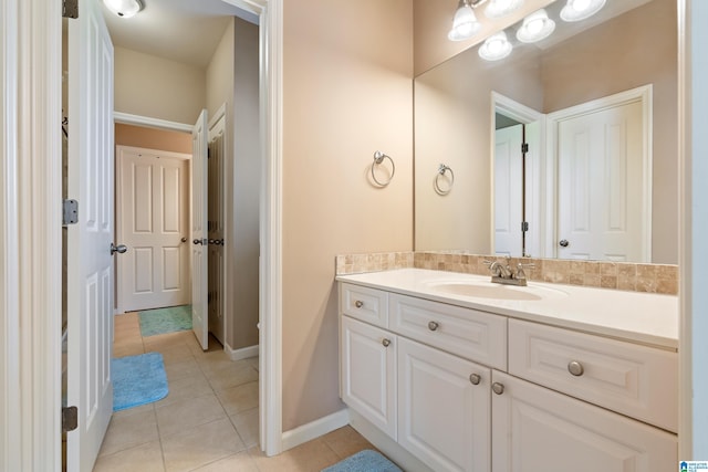 bathroom with tile patterned flooring, vanity, and baseboards