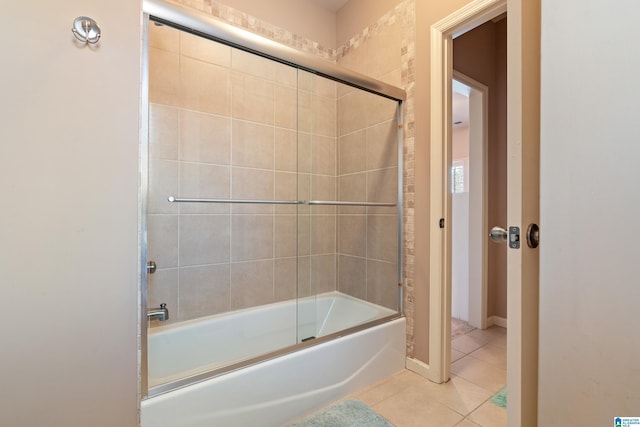 bathroom featuring tile patterned flooring and enclosed tub / shower combo