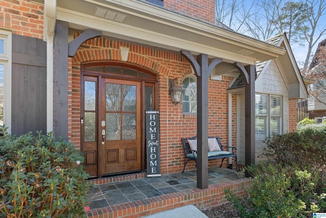 view of exterior entry with brick siding