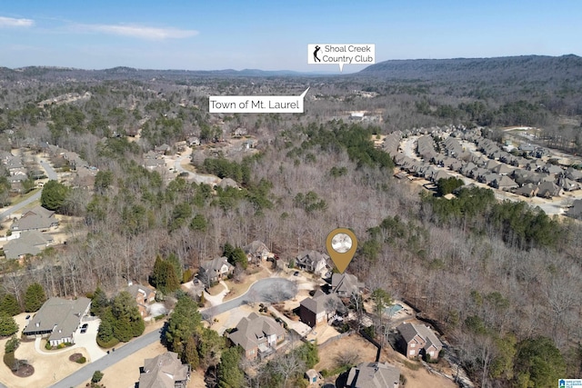 bird's eye view featuring a wooded view and a residential view