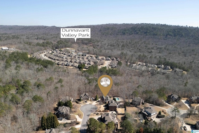 birds eye view of property with a forest view