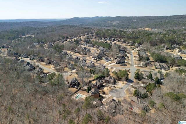 drone / aerial view with a mountain view and a view of trees