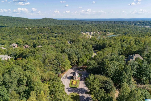 aerial view with a forest view and a water view