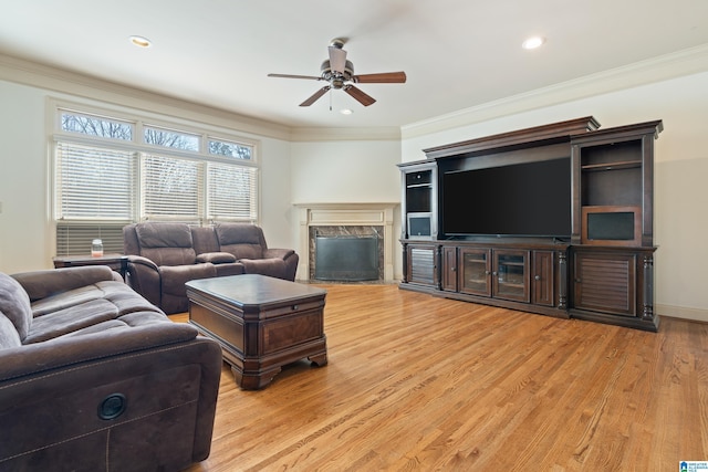 living area featuring a fireplace, crown molding, recessed lighting, ceiling fan, and light wood-type flooring