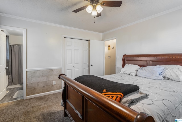 bedroom with a textured ceiling, a closet, carpet flooring, and crown molding