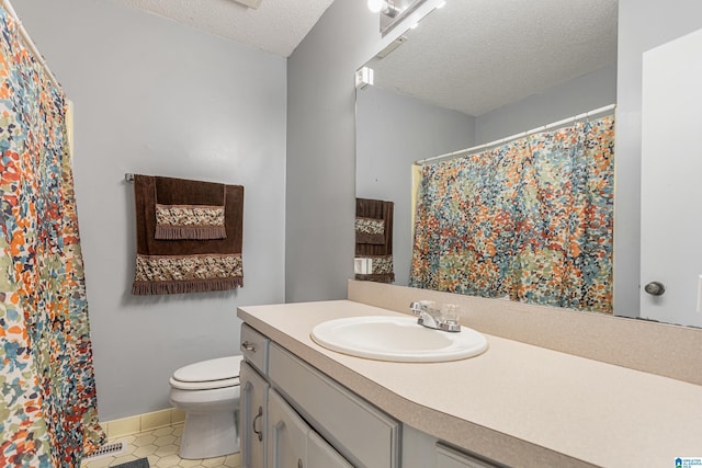 bathroom with a shower with curtain, toilet, a textured ceiling, vanity, and tile patterned flooring