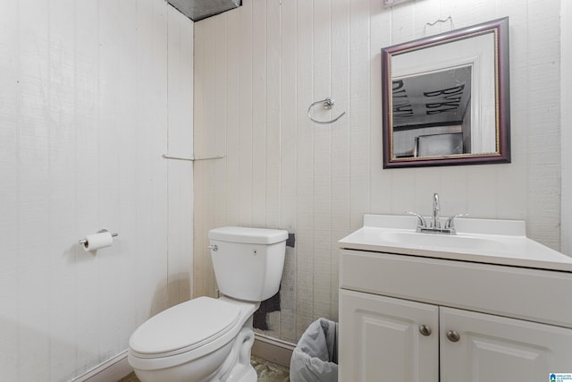 half bathroom with toilet and vanity