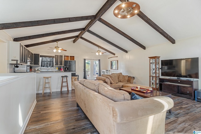 living area featuring vaulted ceiling with beams, dark wood-style floors, and a ceiling fan