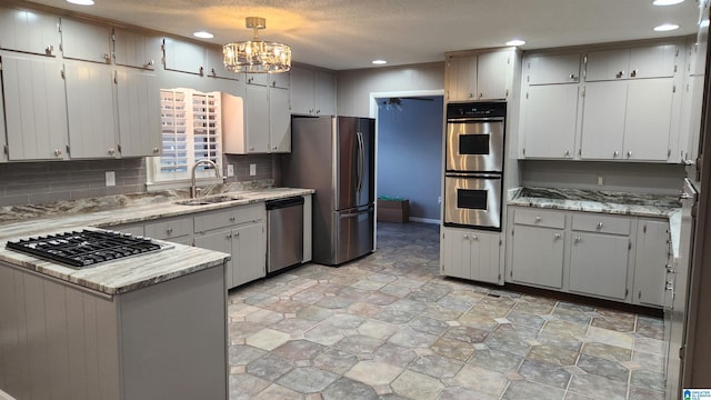 kitchen with stainless steel appliances, recessed lighting, a sink, and backsplash