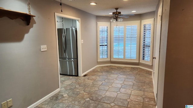 unfurnished dining area with recessed lighting, ceiling fan, and baseboards