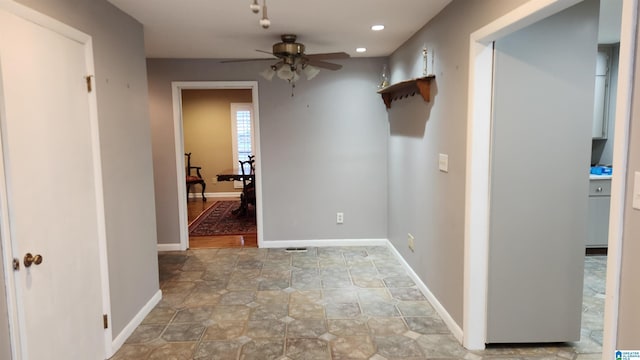 corridor featuring recessed lighting and baseboards