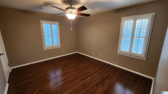 unfurnished bedroom featuring dark wood-style floors, visible vents, and baseboards