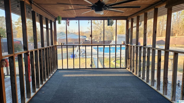 unfurnished sunroom featuring a ceiling fan