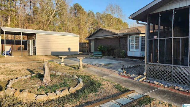 view of yard with a sunroom and a patio area